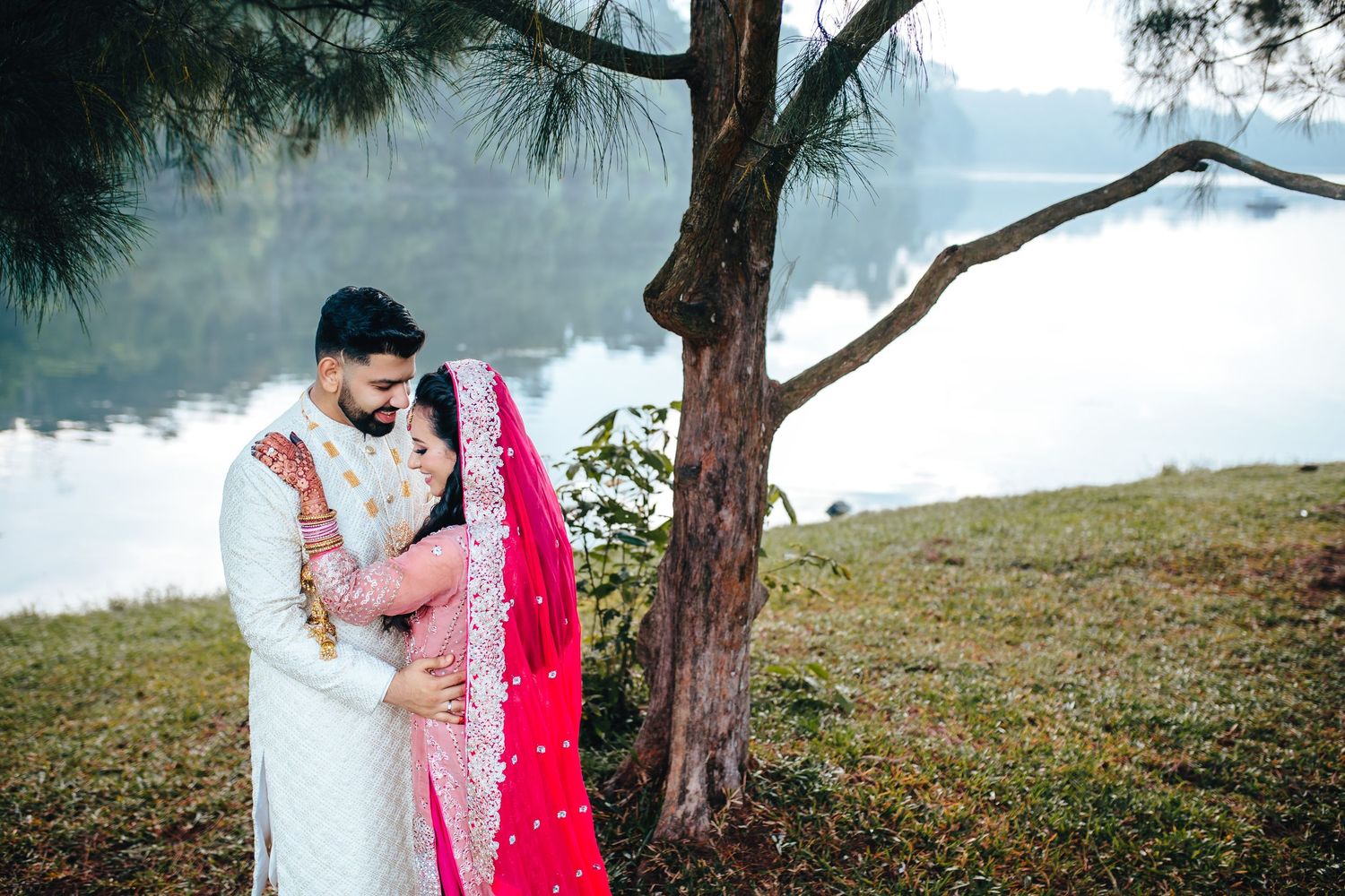 Couple standing near lake with trees, peaceful pre wedding photography Singapore