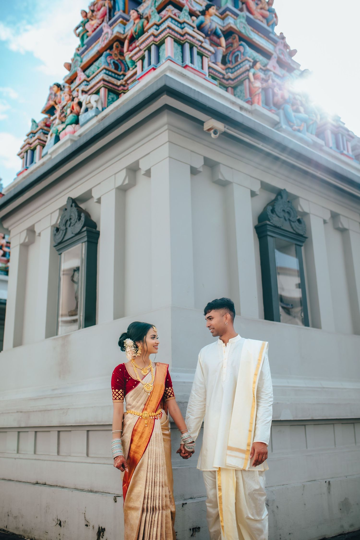 Hindu temple wedding couple near temple architecture, traditional ceremony Singapore