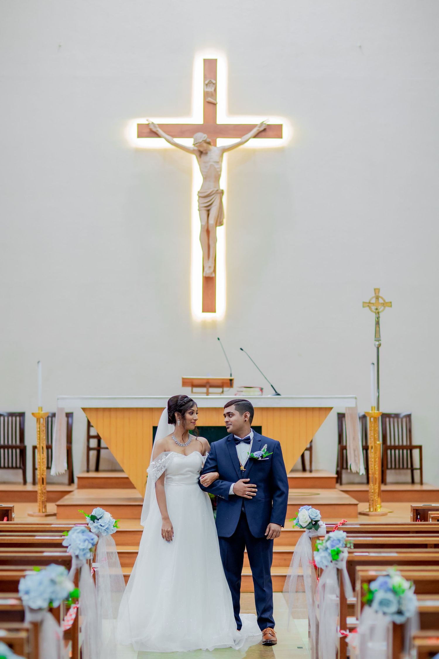 Church wedding ceremony with cross altar, bride and groom walking aisle Singapore