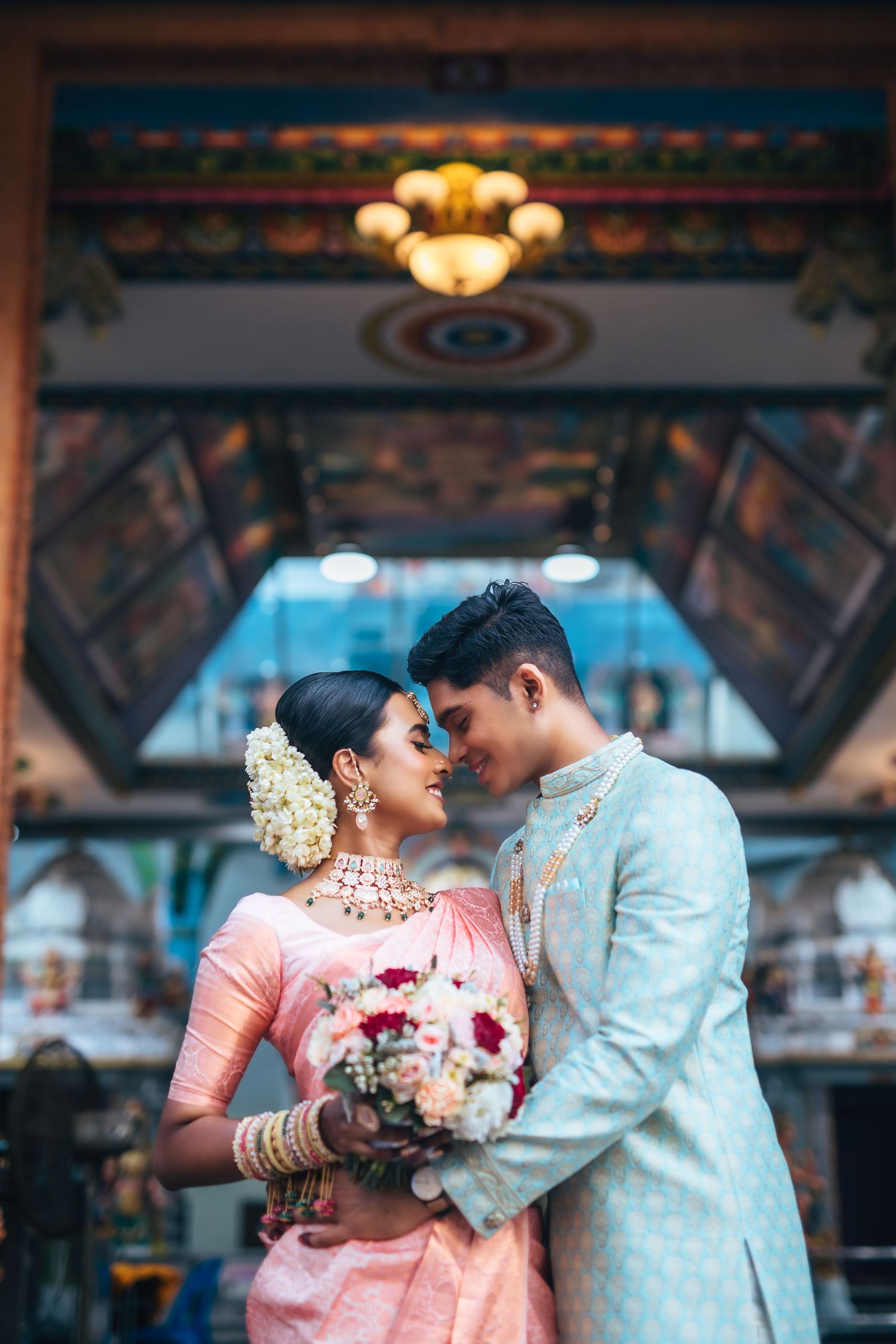 Couple inside temple hall, romantic traditional wedding portrait