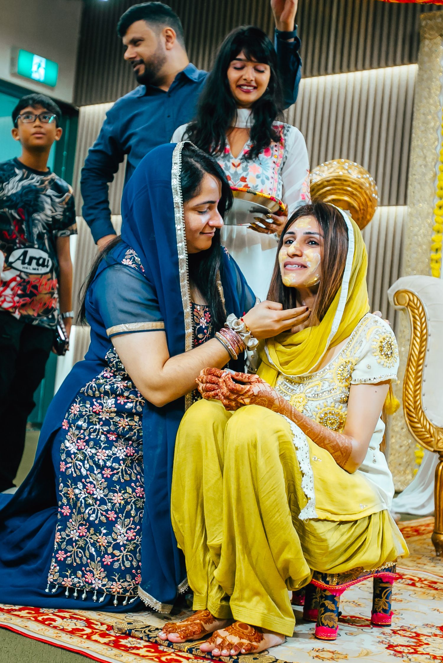Family gathered during Indian pre wedding ceremony, joyful candid moment
