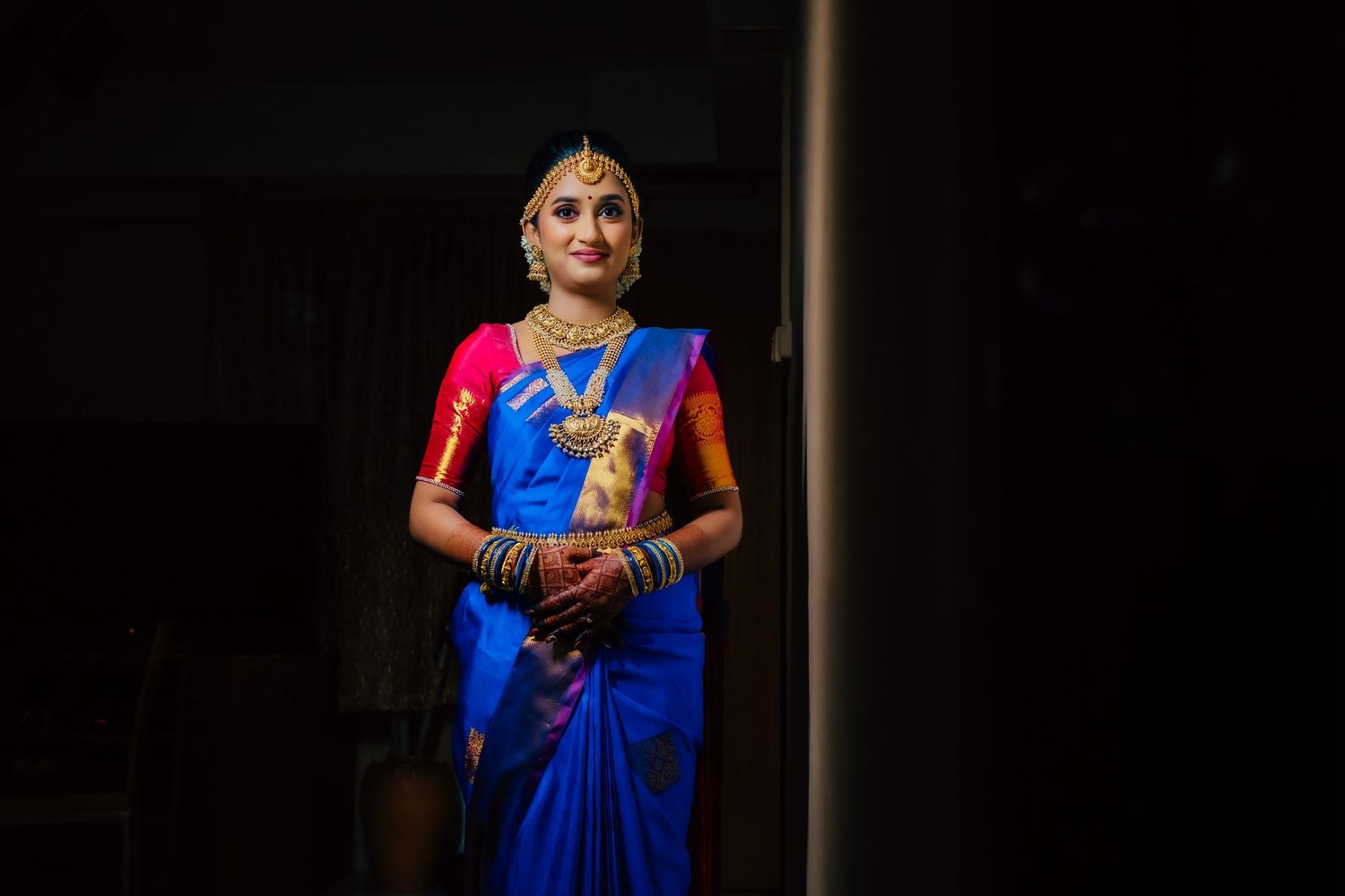 Full-length bride portrait in saree with dramatic lighting