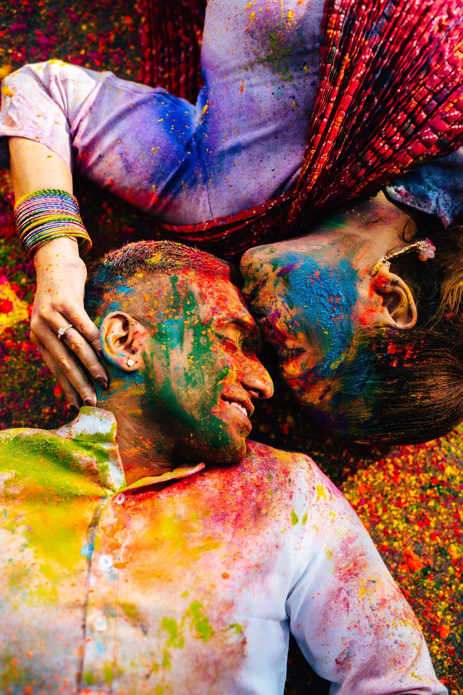 Holi Themed pre wedding close-up with colorful powders, vibrant wedding celebration