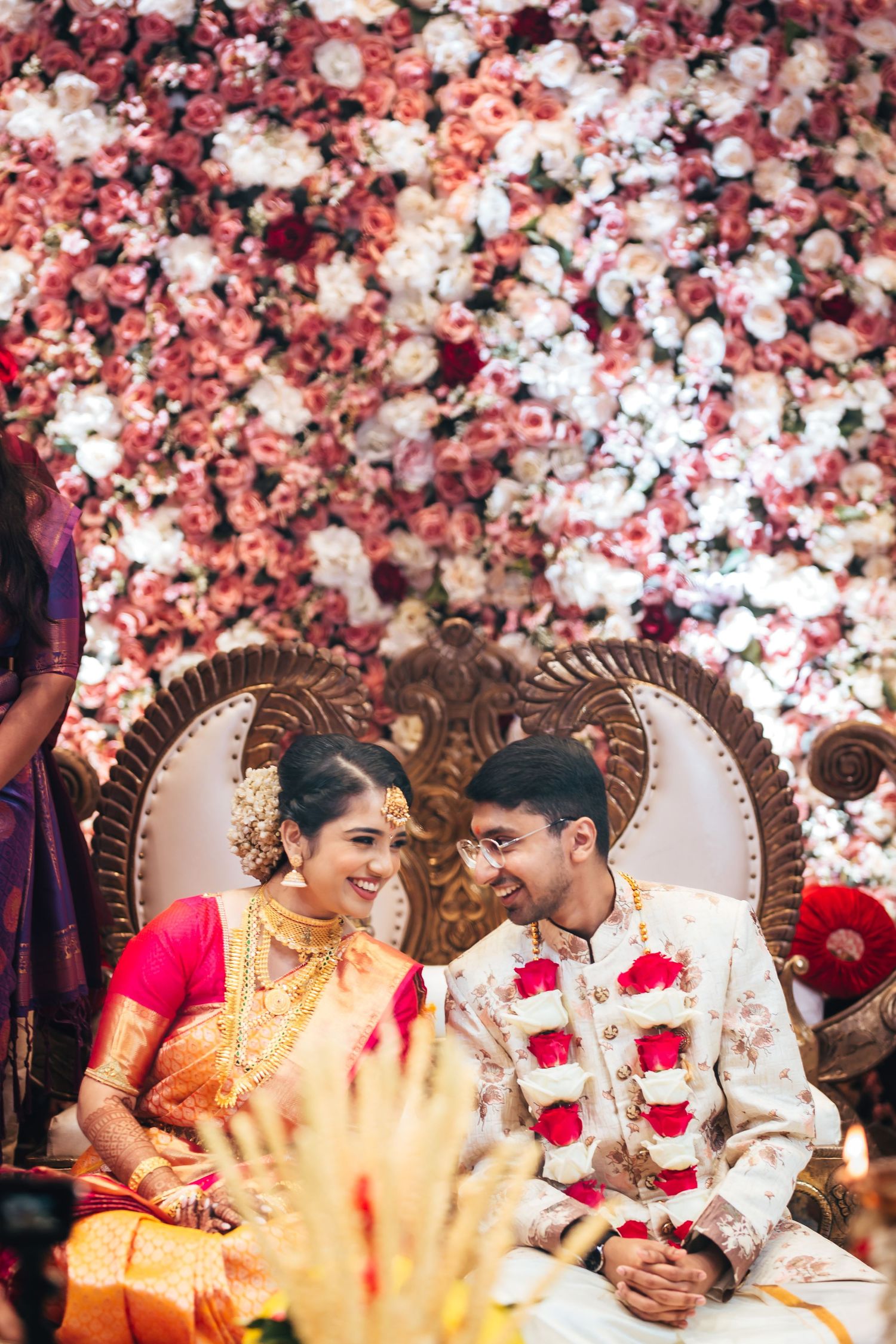 South Indian wedding couple seated under floral mandap Singapore