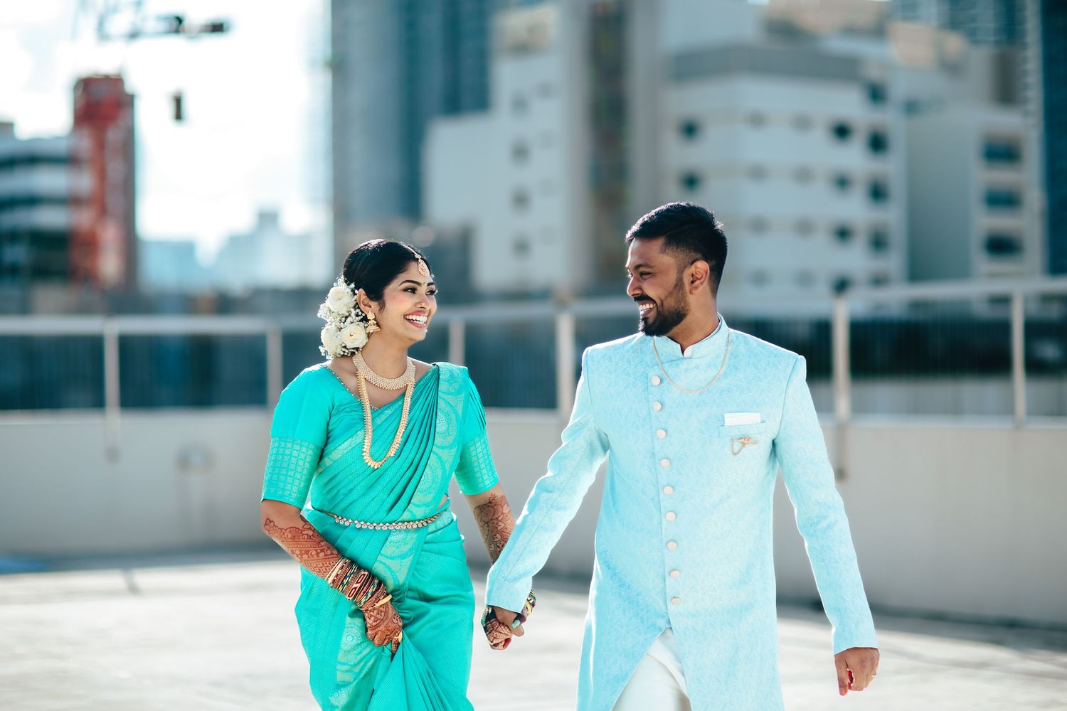 Couple walking hand in hand in traditional attire, wedding photography Singapore