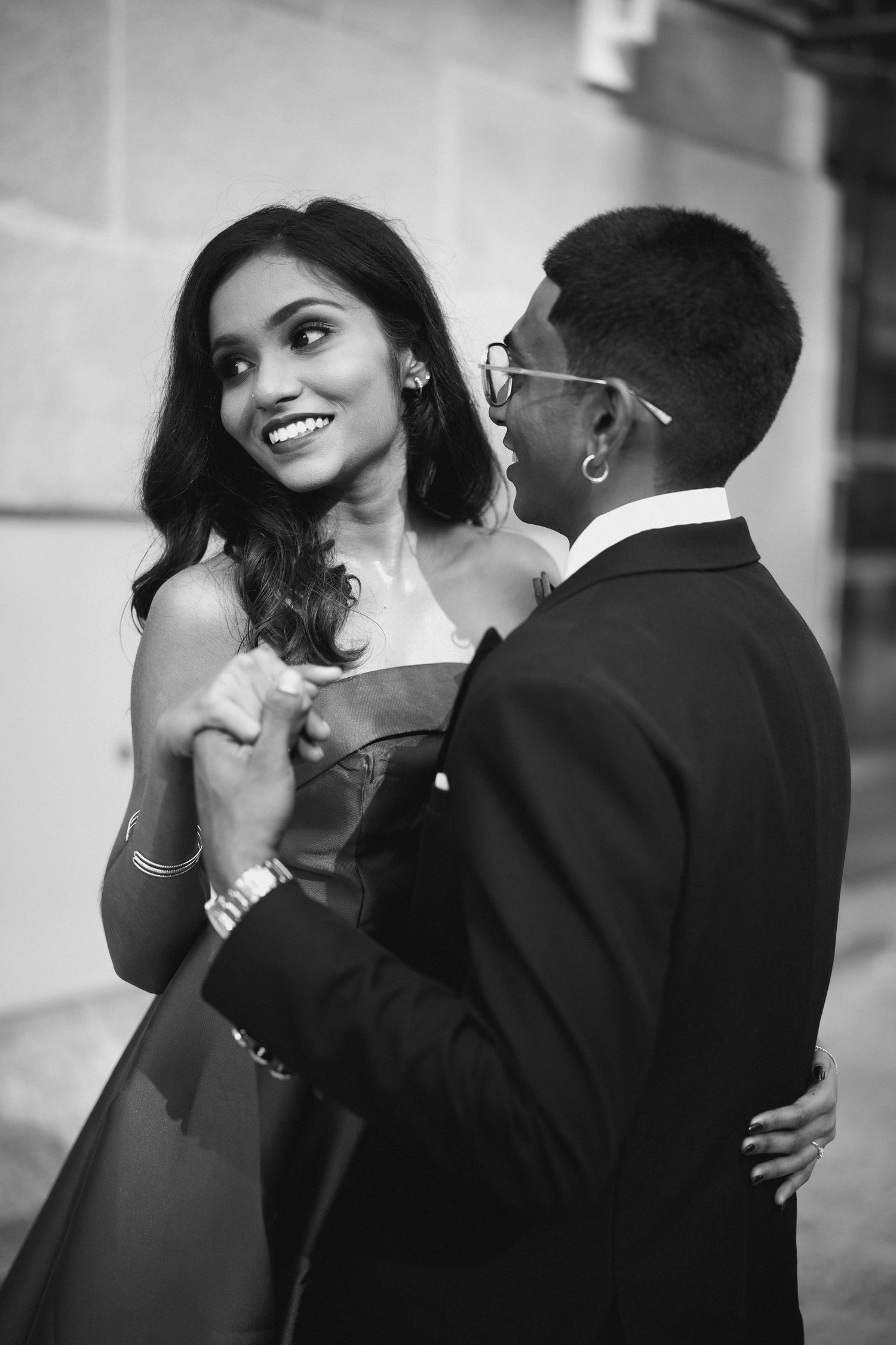Black and whiteCouple portrait against minimal architectural wall, editorial style