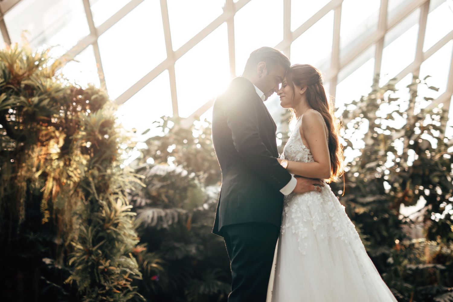 Couple embracing in warm sunset light, romantic outdoor photography Singapore in Gardens by the Bay