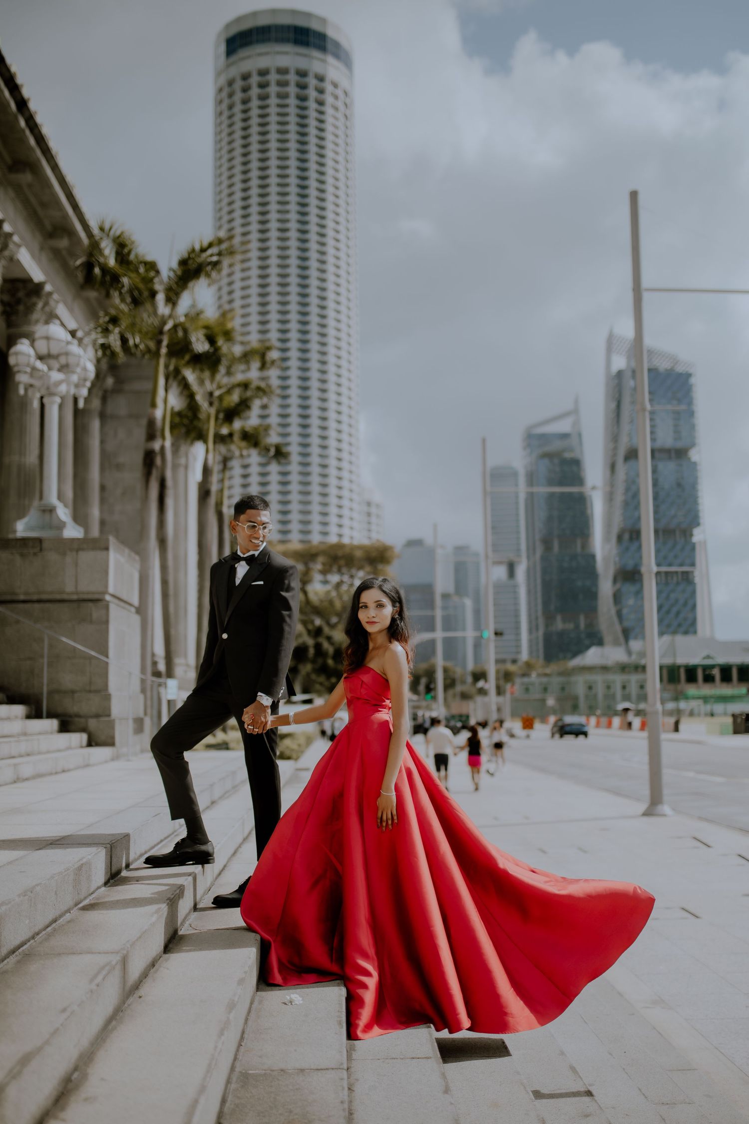 Couple in formal wear with city skyline backdrop, luxury pre wedding photography Singapore