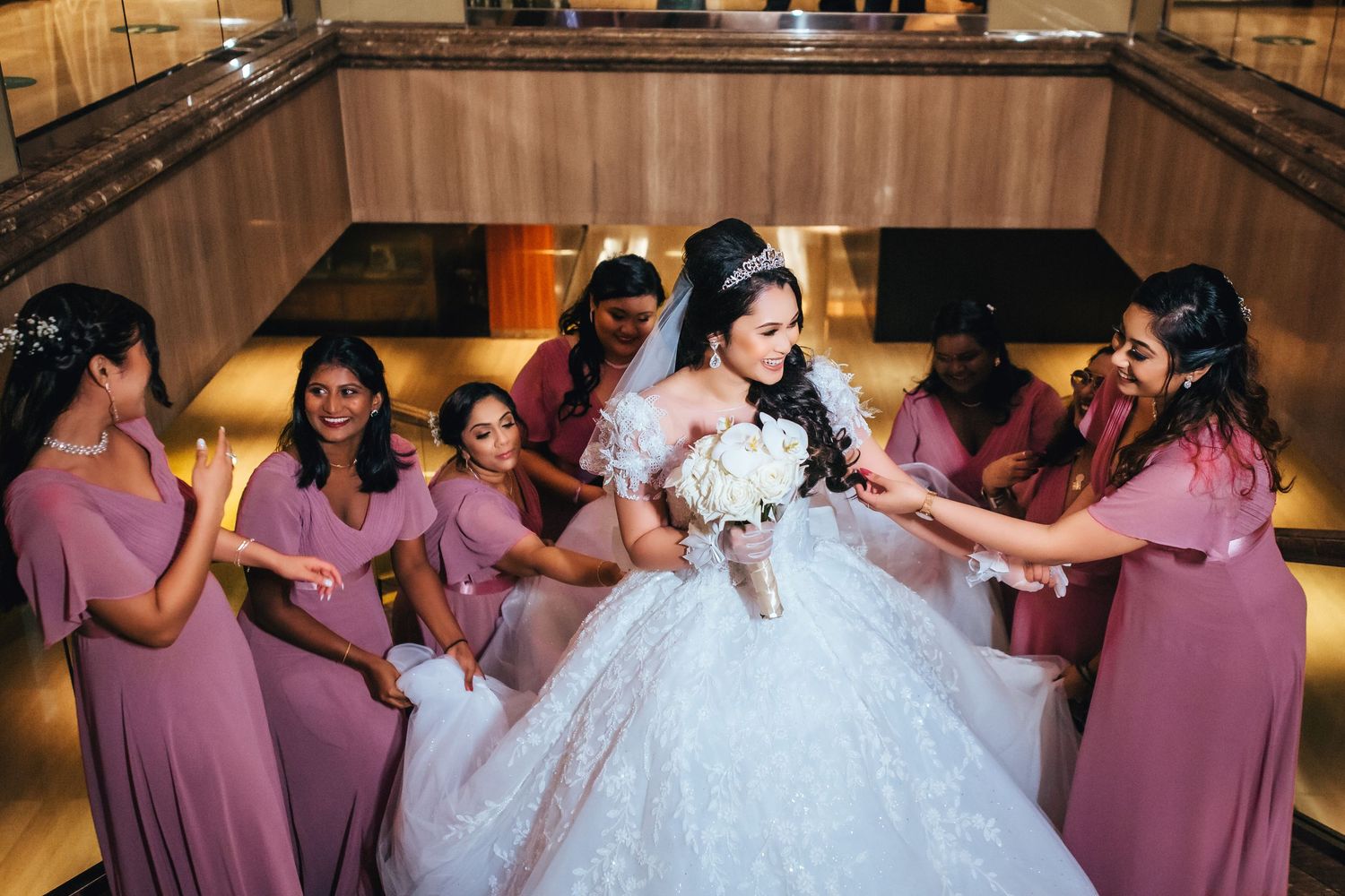 Bride surrounded by bridesmaids during reception celebration