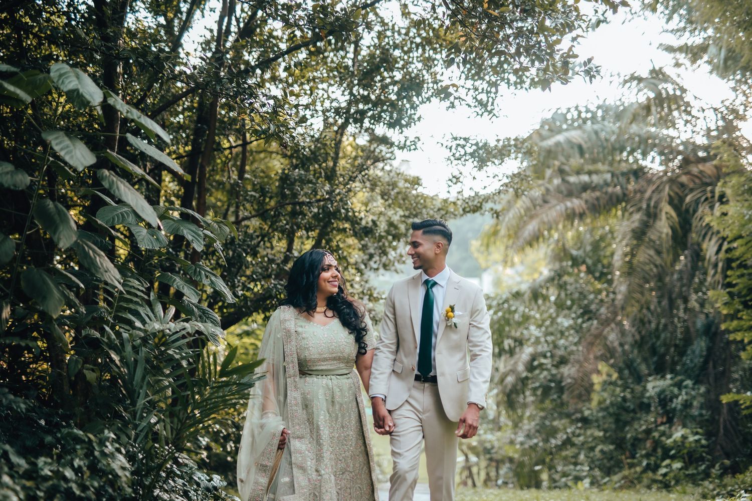 Couple walking through lush greenery, natural pre wedding photography Singapore