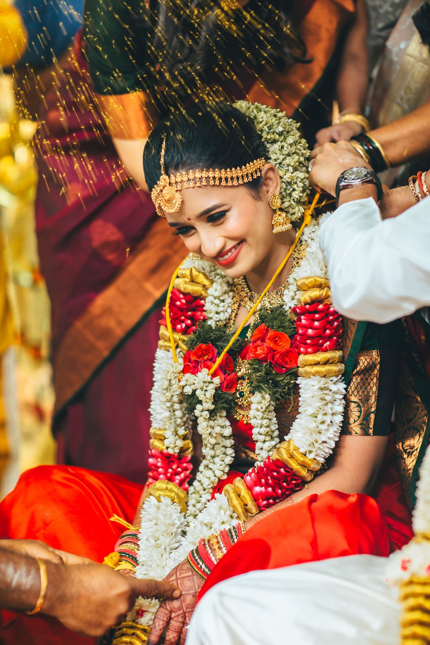 Bride during wedding ritual with floral garland, traditional ceremony