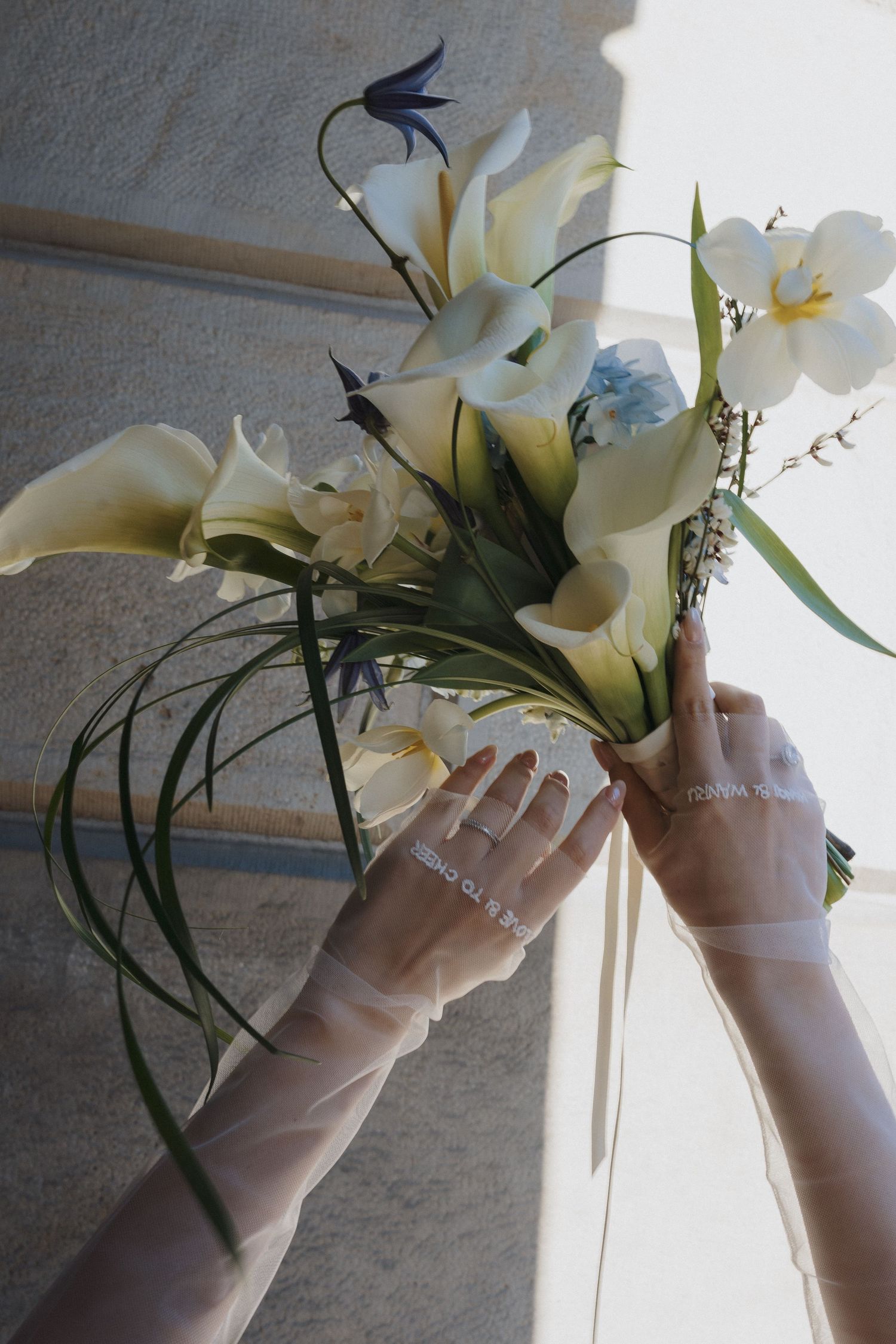 Classic bridal bouquet with calla lilies, orchids, and blue flowers at Osgoode Hall for Toronto City Hall wedding photography.