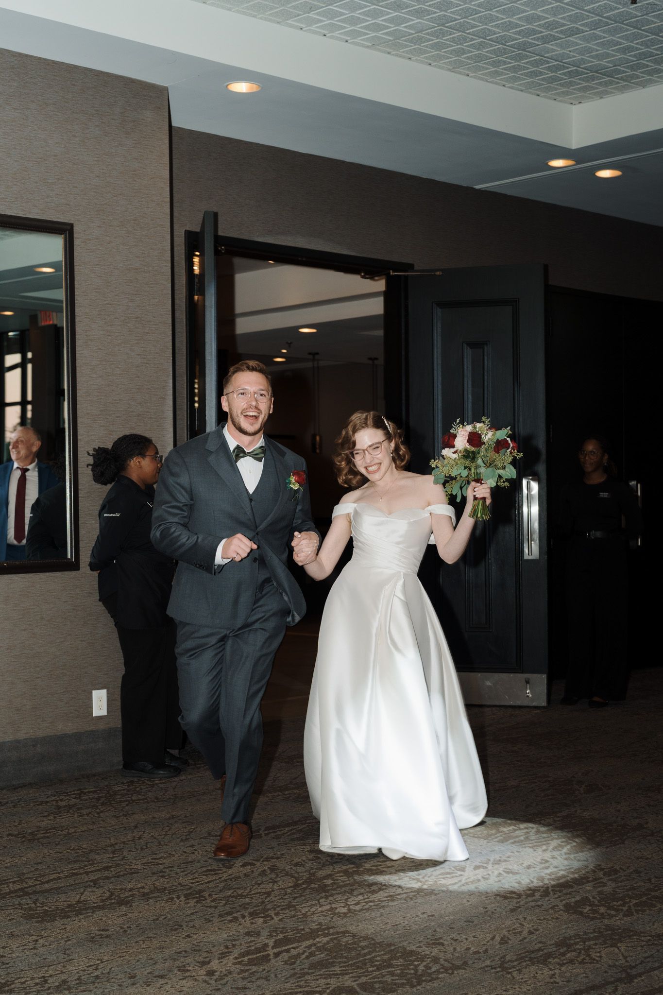 Joyful newlyweds making their reception entrance at The Manor in King City during their Jewish wedding celebration.