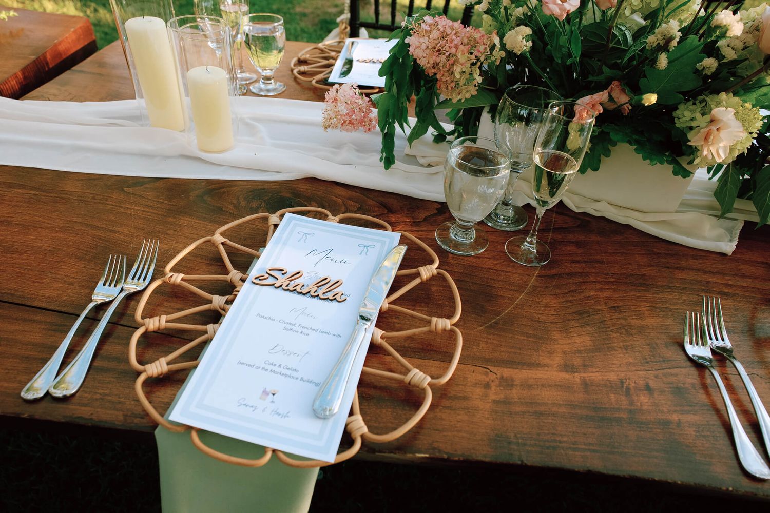 Elegant wedding table setting with menus, candles, glassware, and florals at Kurtz Orchards in Niagara-on-the-Lake reception.
