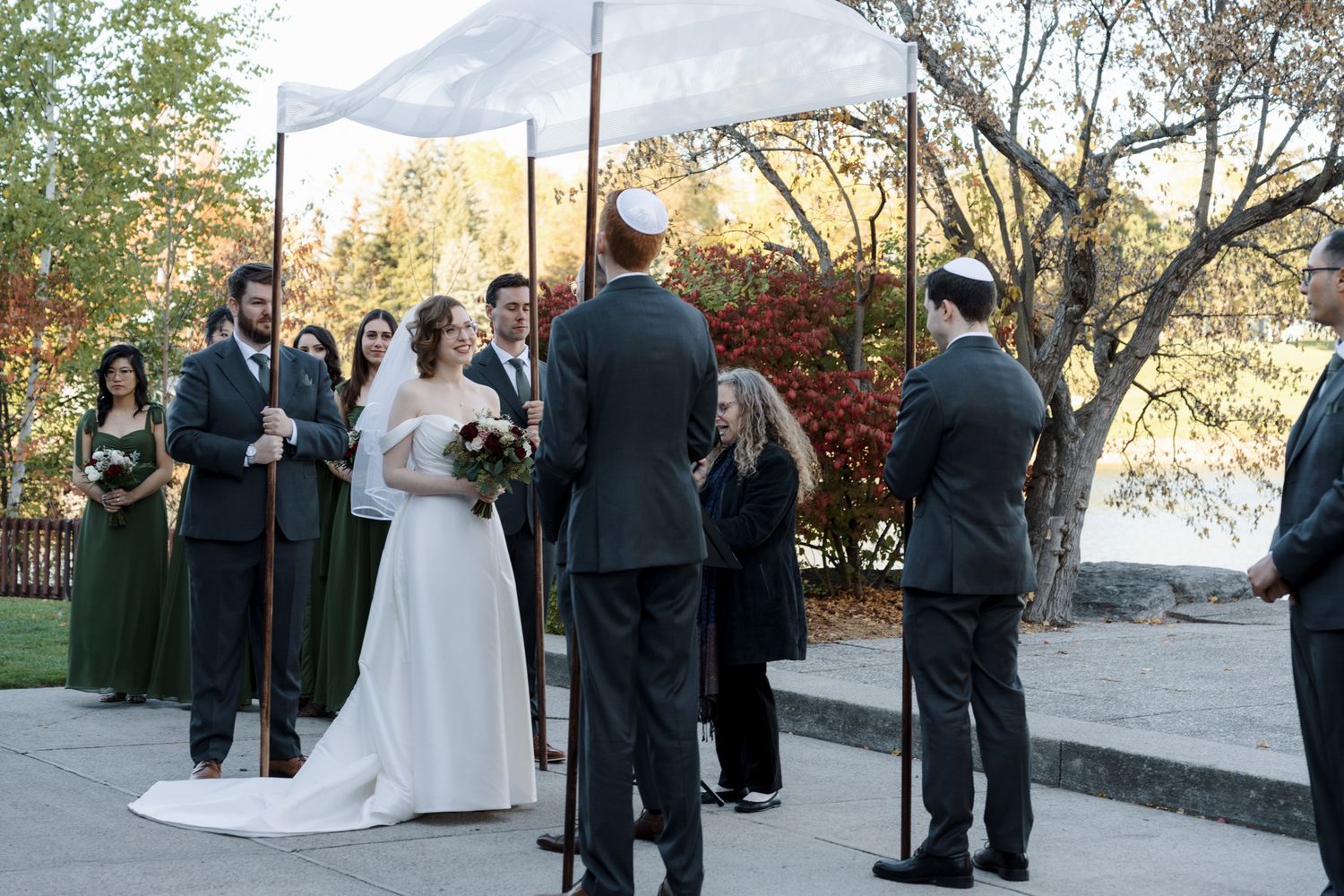 Bride and groom beneath a chuppah at The Manor in King City during their outdoor Jewish wedding ceremony.