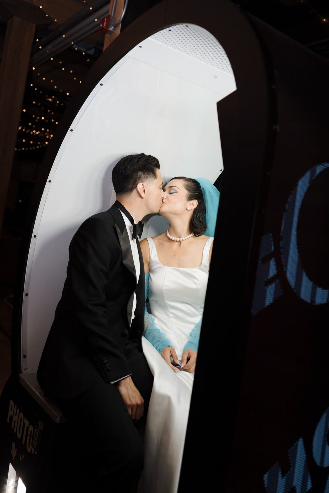 Bride and groom kissing inside a photo booth at Greta Bar Toronto during their wedding reception for candid Toronto wedding photography.
