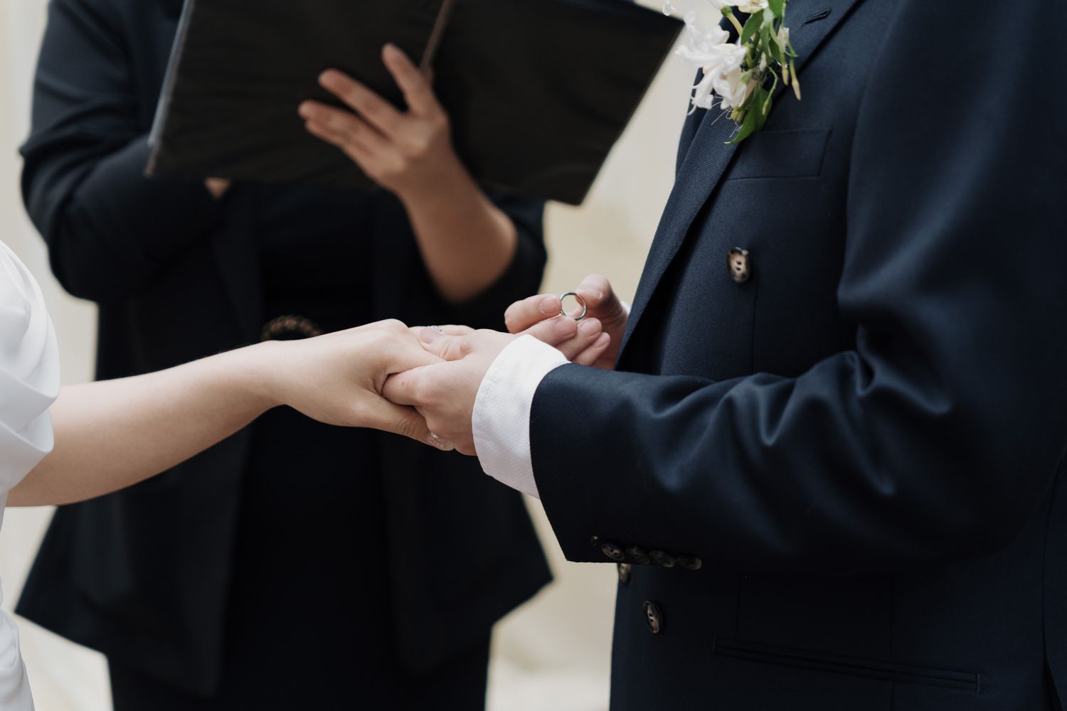 Groom placing a wedding ring on the bride’s hand during a Razi Estate forest wedding ceremony in Schomberg, Ontario.
