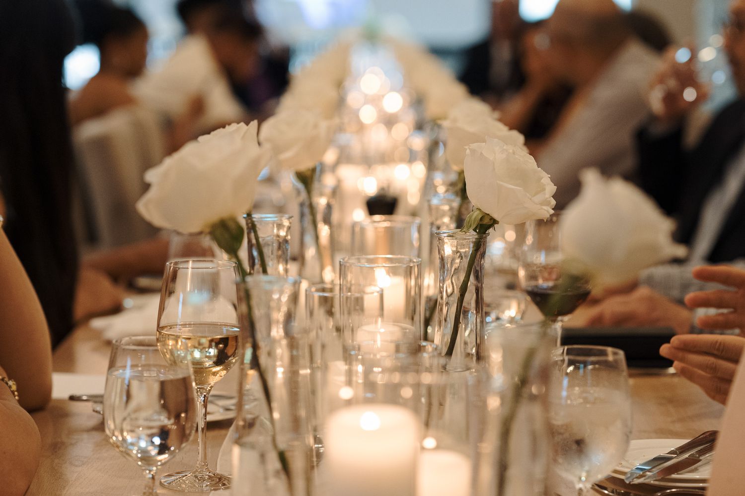 Bride and groom taking a selfie at Cambridge Mill in Cambridge, Ontario with white roses and candlelit reception décor.