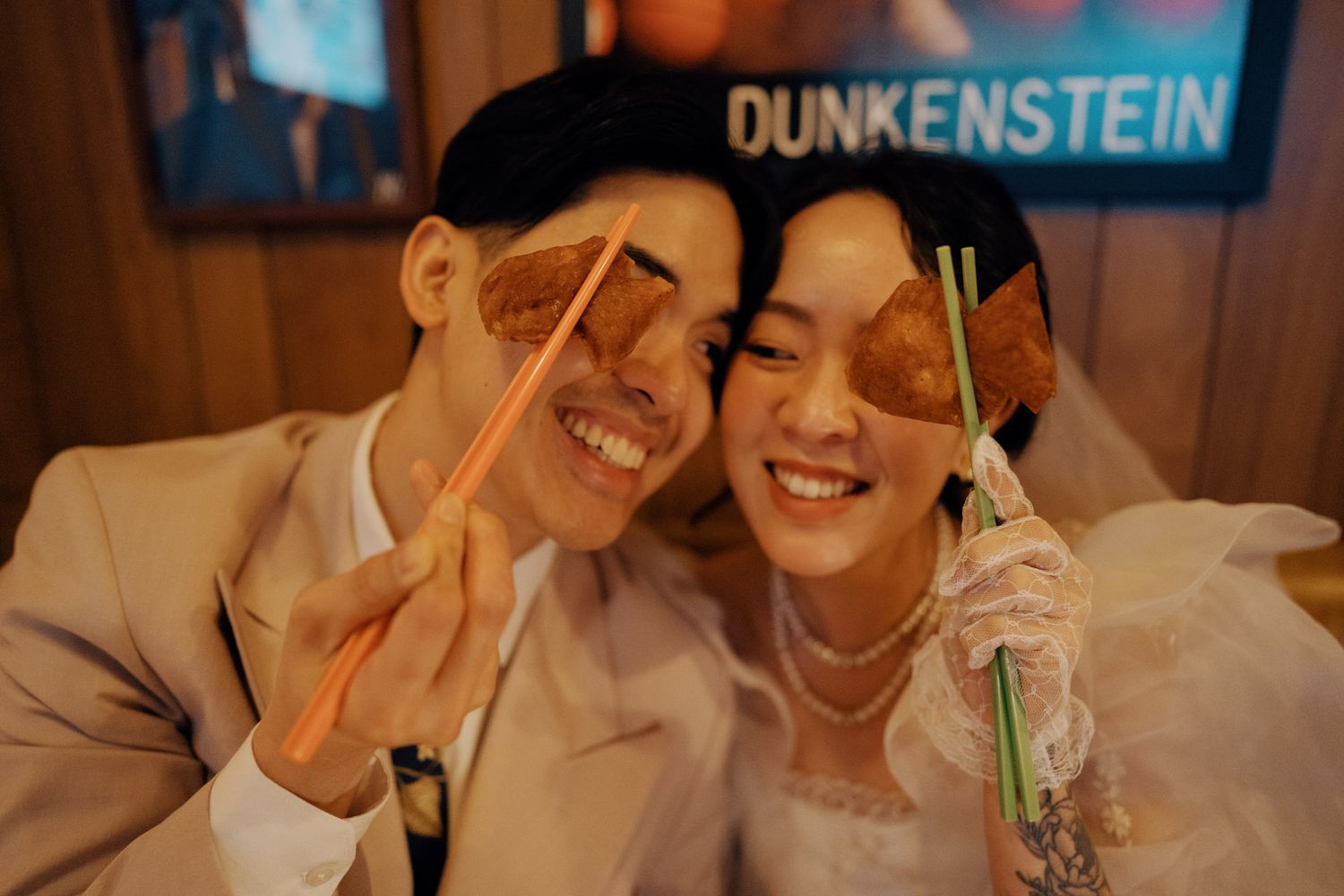 Couple with drinks at Big Trouble in Toronto Chinatown during an 80s Hong Kong-inspired engagement photo session