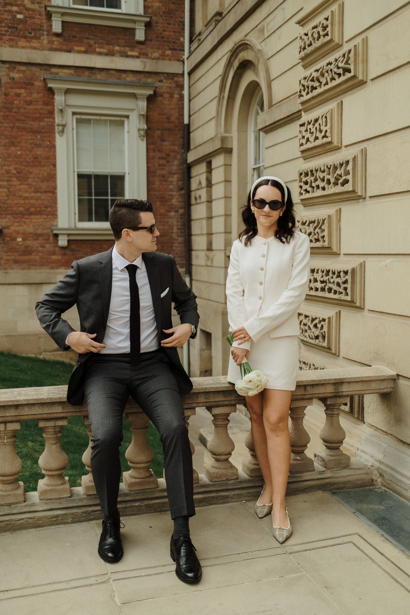 Bride and groom posing outside Osgoode Hall in Toronto for editorial Toronto City Hall wedding photography