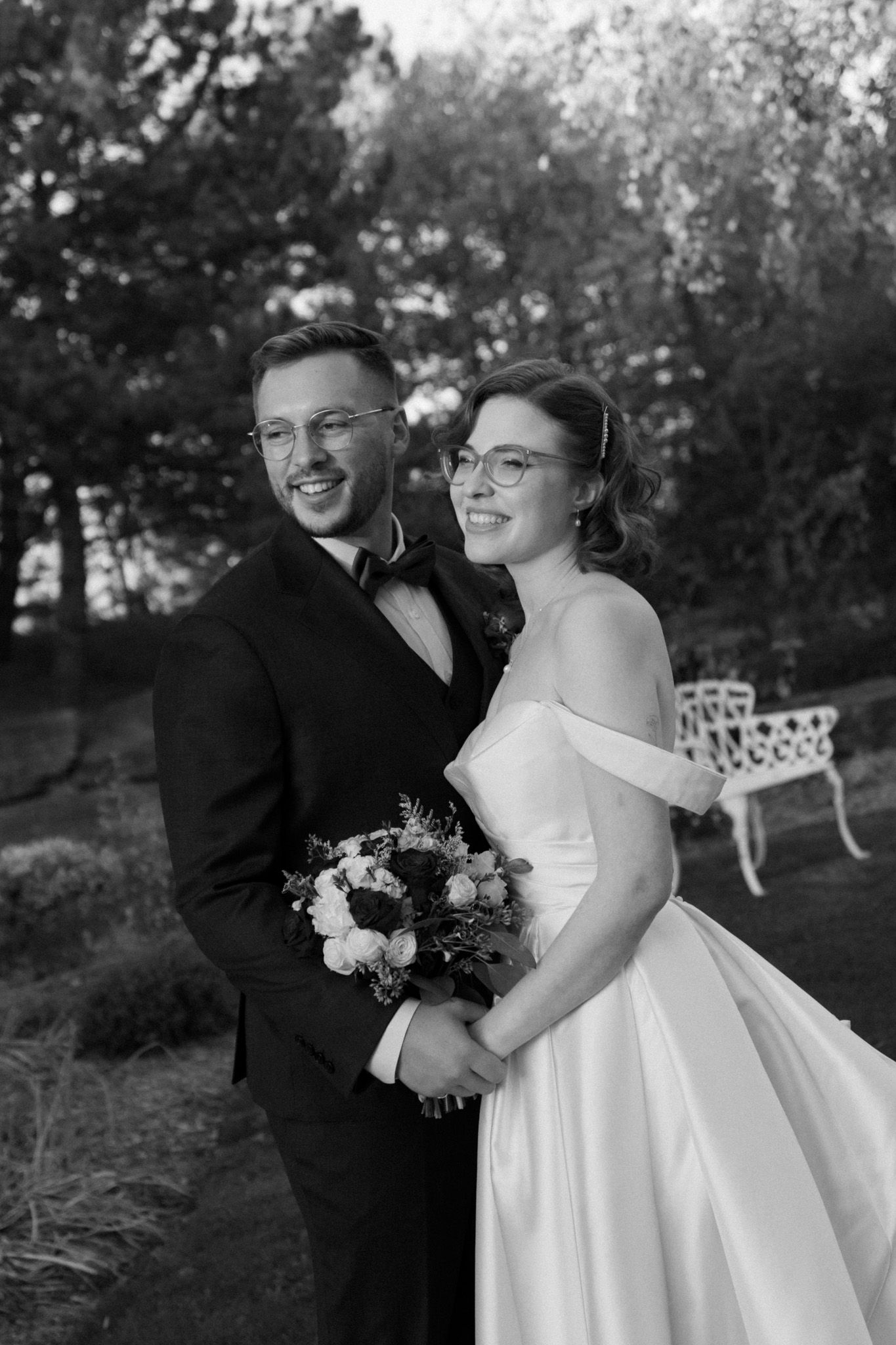 Black and white bride and groom smiling outdoors at The Manor in King City during their Jewish wedding portraits.