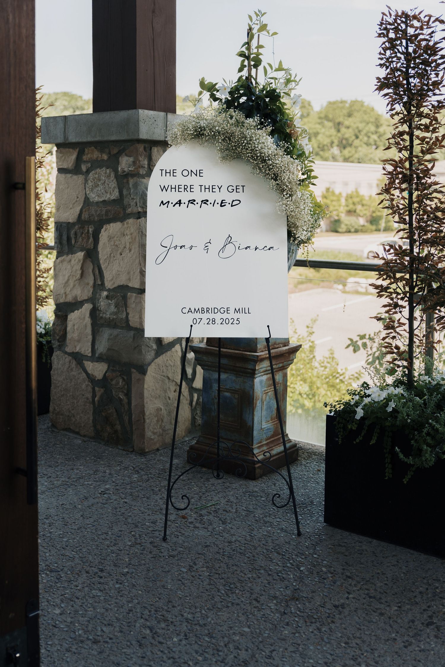 Friends-themed wedding welcome sign for Sean and Bianca at Cambridge Mill in Cambridge, Ontario with floral décor.