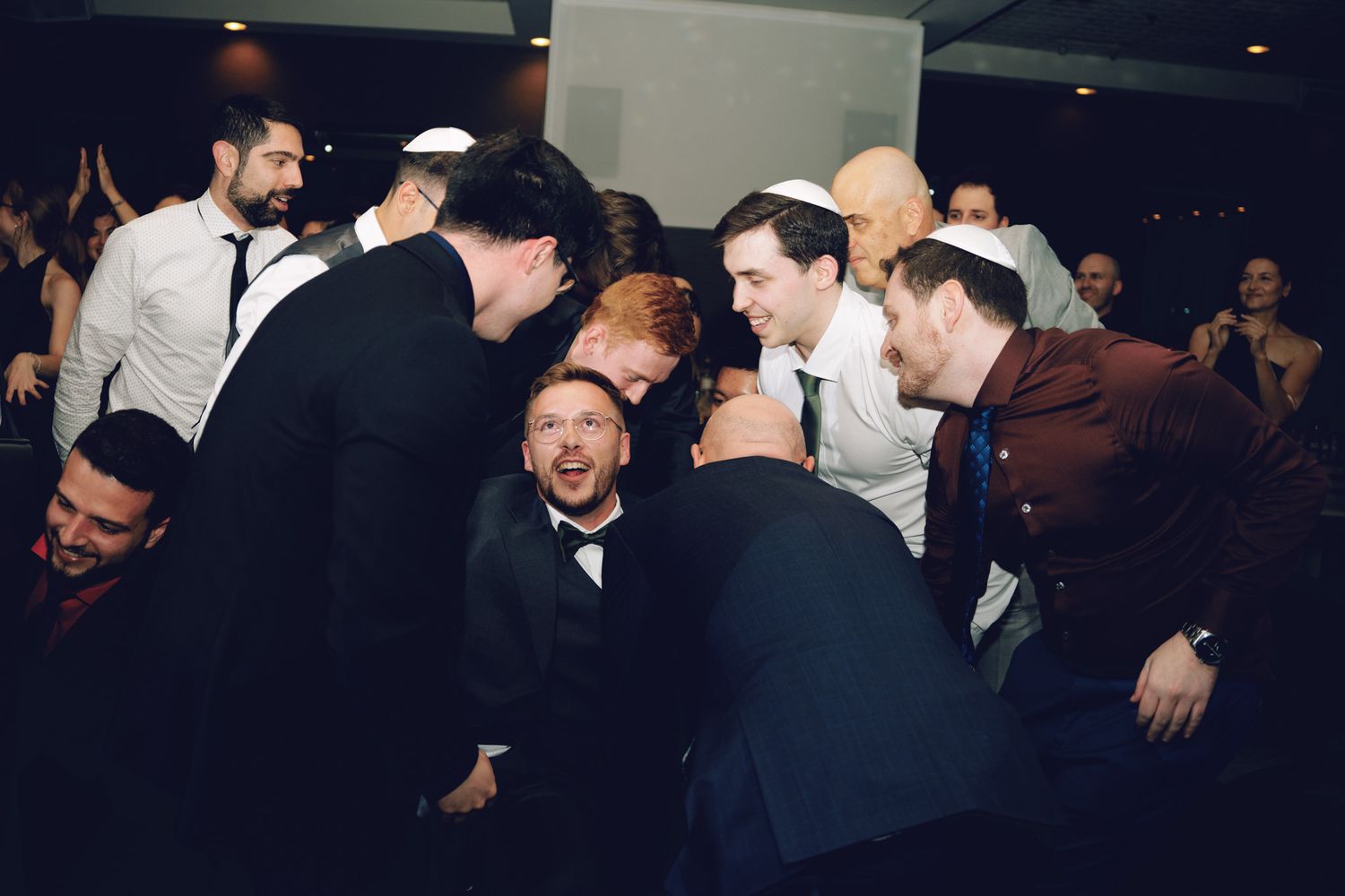 Men in formal attire celebrating on the dance floor at The Manor in King City during a Jewish wedding reception.