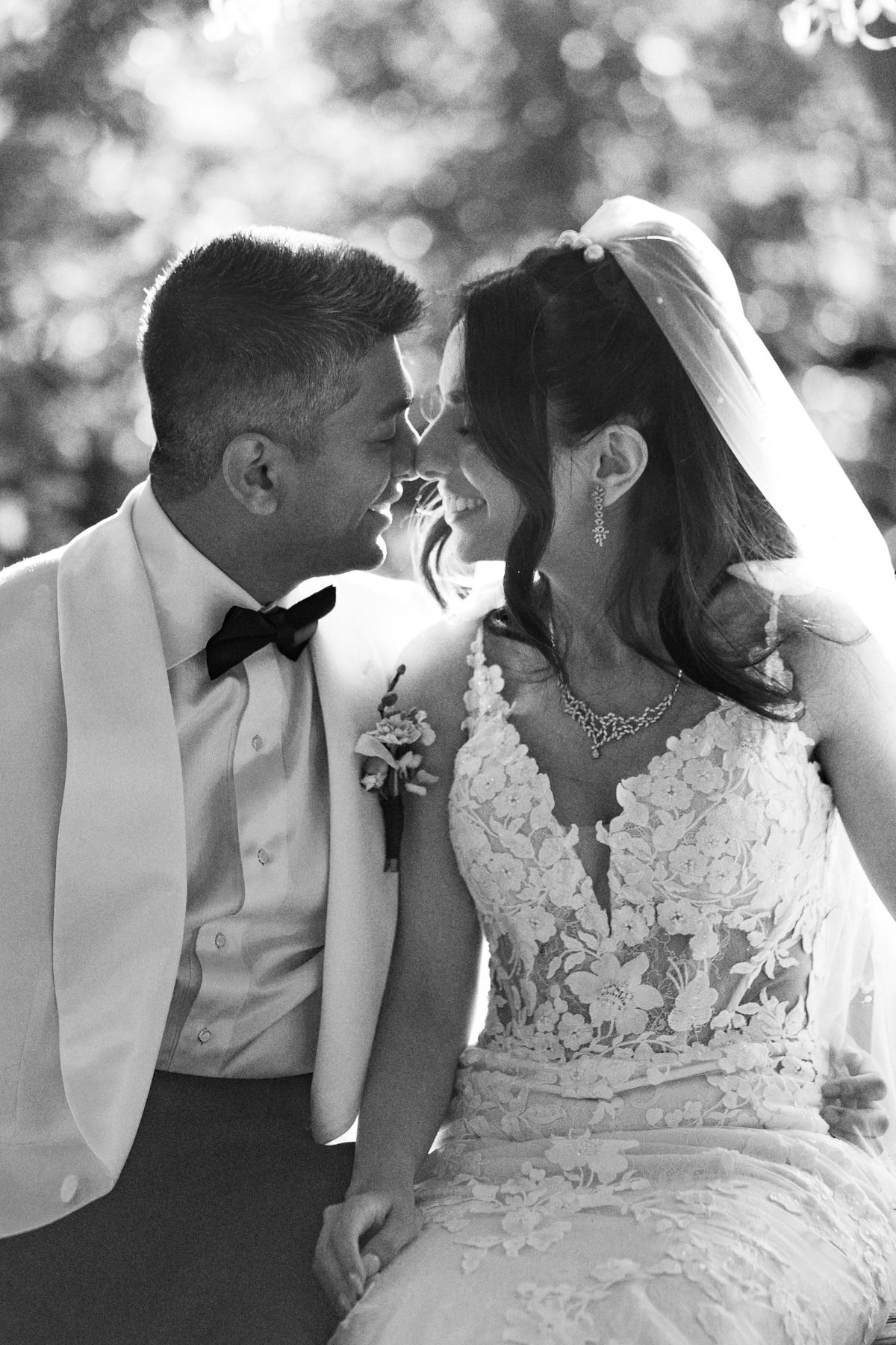 Black and white bride and groom touching foreheads at Kurtz Orchards in Niagara-on-the-Lake for romantic wedding photography.
