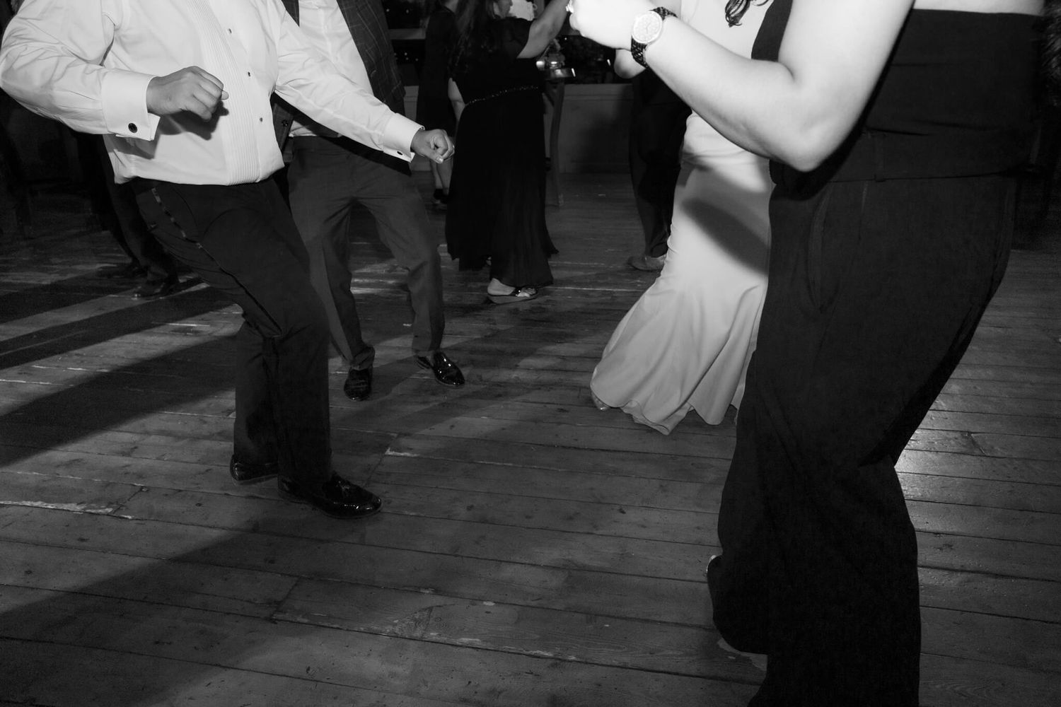 Black and white couple dancing on a wooden floor at Kurtz Orchards in Niagara-on-the-Lake for candid wedding photography.