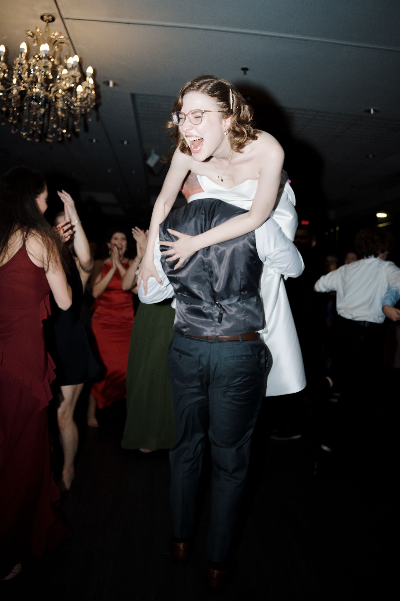 Joyful groom lifting the bride on the dance floor at The Manor in King City for Toronto wedding photography