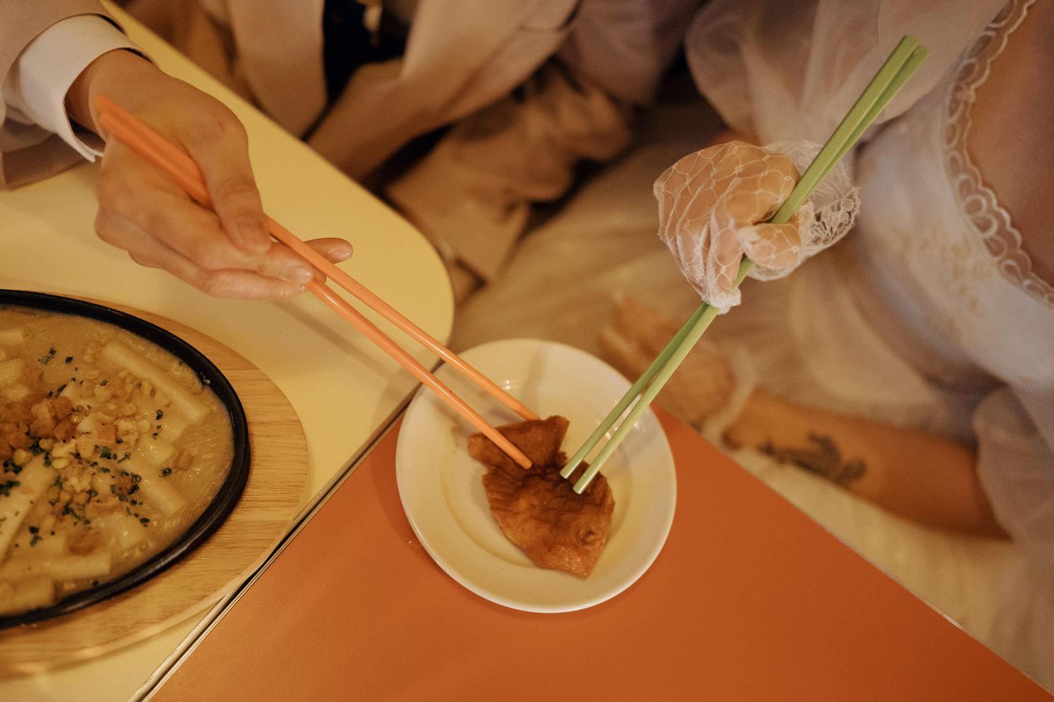Korean-style pre-wedding food scene with chopsticks serving a shared meal in Toronto Chinatown for documentary wedding photography.