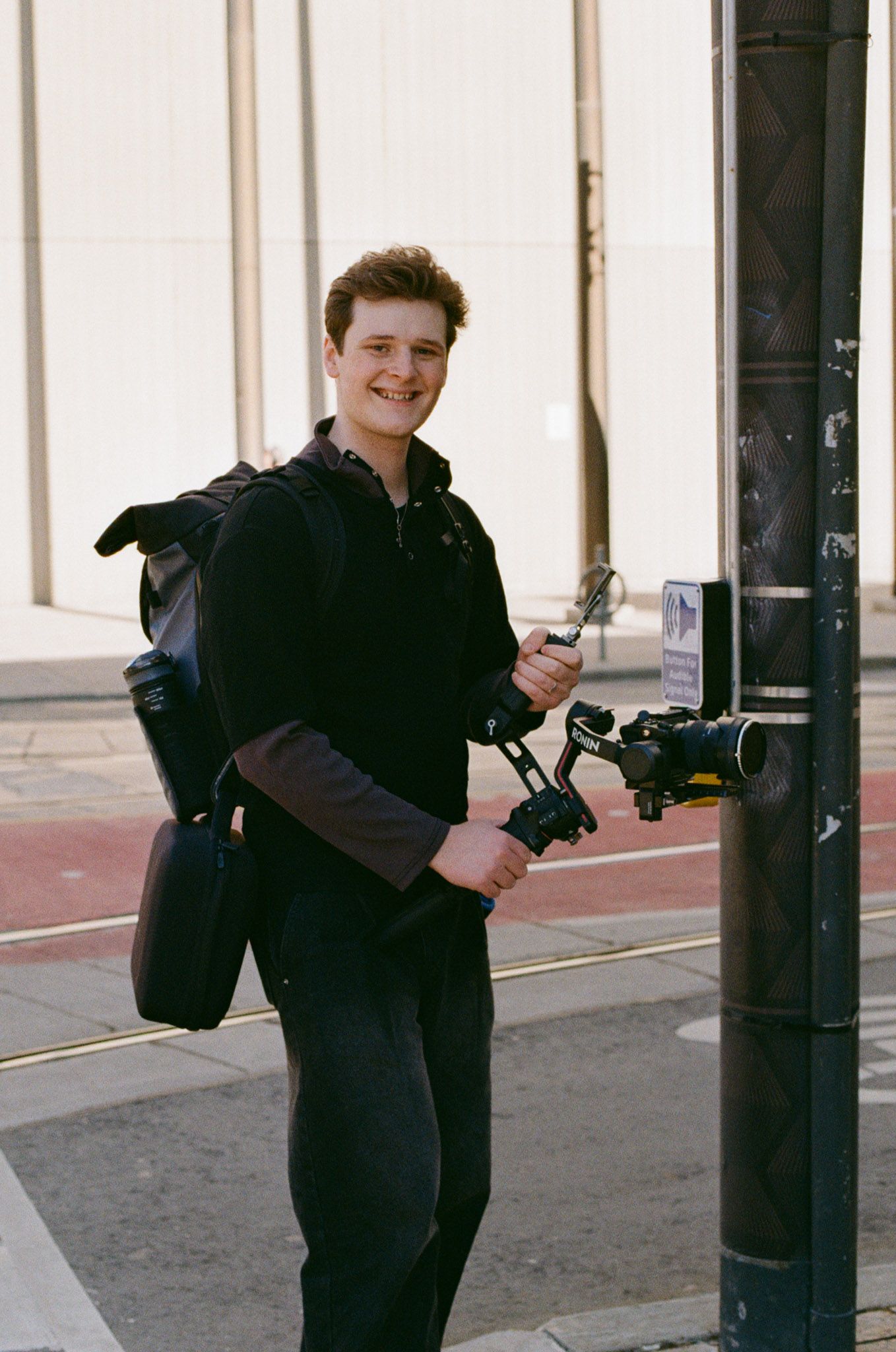 ILO Studio founder Bradley Hazelton holding a camera gimbal outside Osgoode Hall in Toronto after a city hall wedding videography session