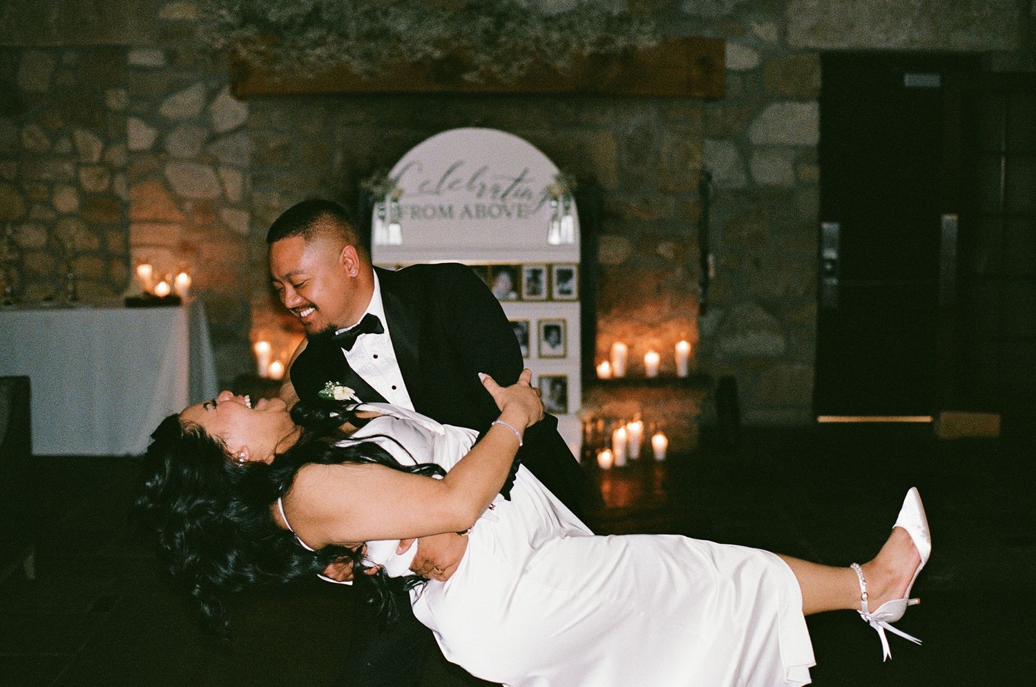 Groom dipping bride during their candlelit first dance at Cambridge Mill in Cambridge, Ontario.