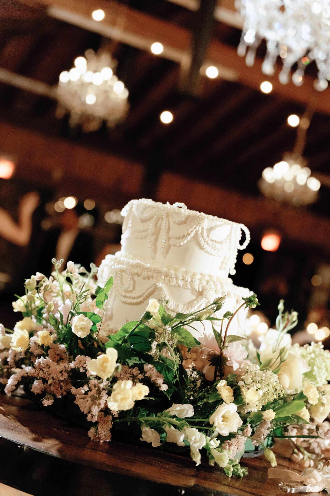 White square wedding cake with pearl details and florals at Kurtz Orchards in Niagara-on-the-Lake wedding reception.