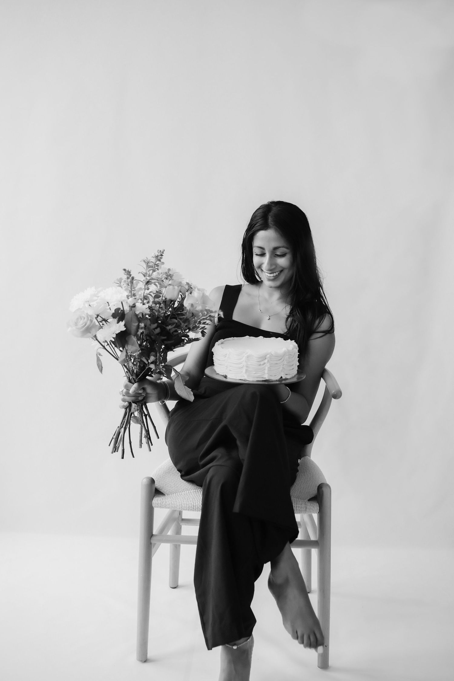 the professional photographer behind Golden Petals Photography, holding a camera in a natural outdoor setting
