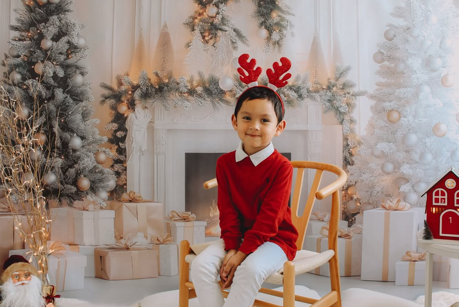 Festive holiday greenery and gold bells used as props in a professional photo studio.
