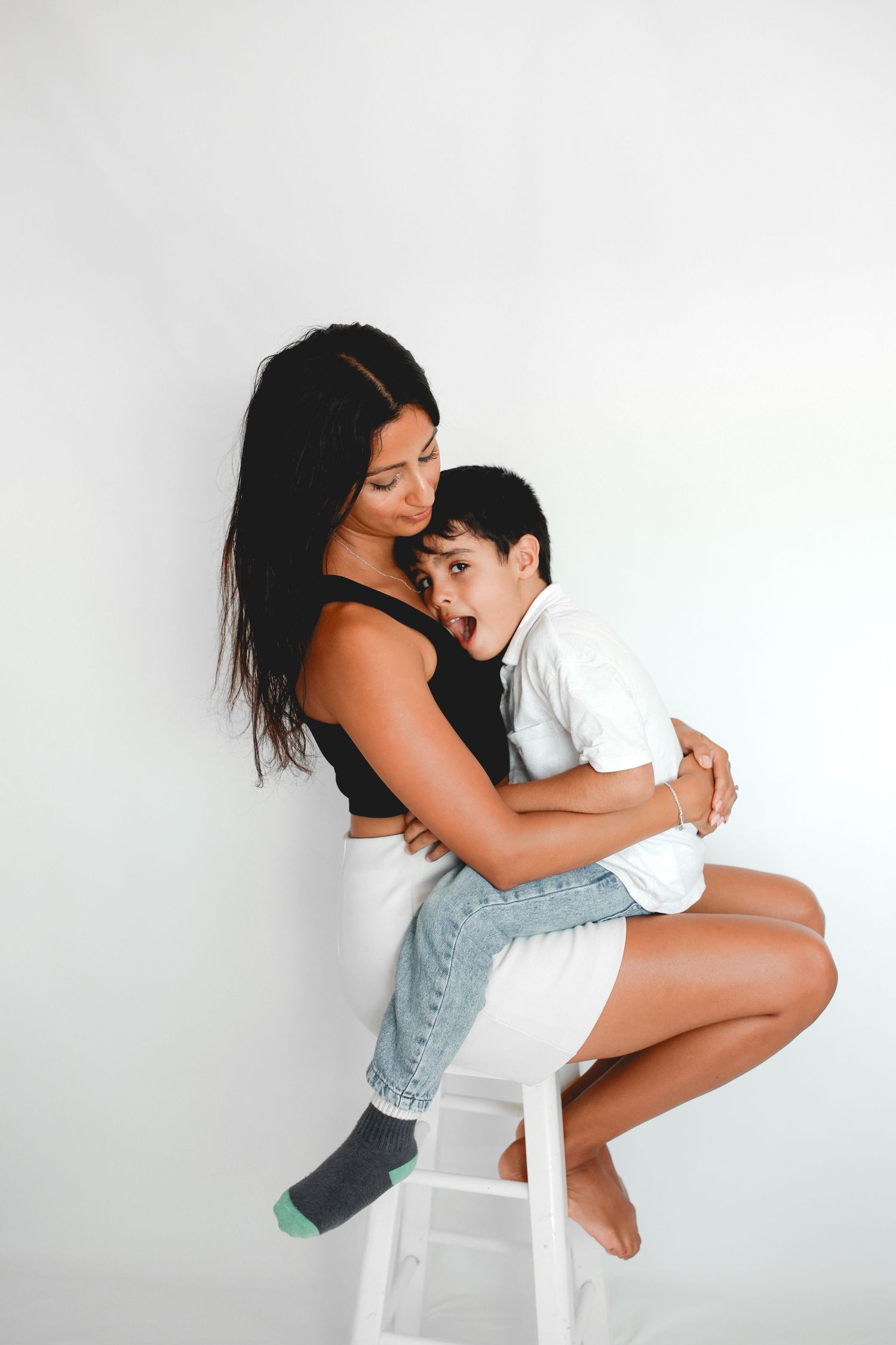 Child giving mum a big hug, Professional Children Studio Photos, Auckland.