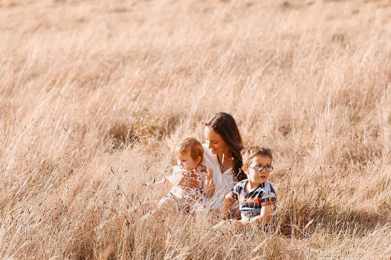 Auckland family photographer taking precious photos during a sunset session at Cornwall Park.