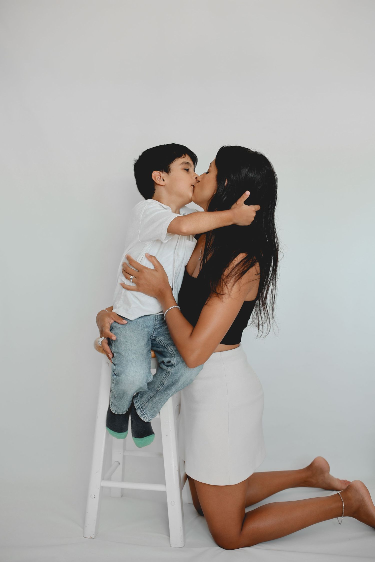Child giving mum a big kiss, Professional Children Studio Photos, Auckland.