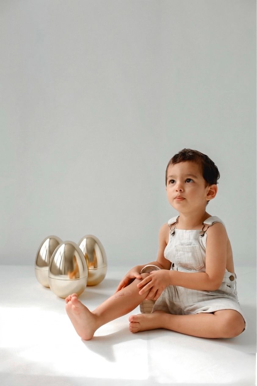 Playful photo of a child playing with easter eggs.