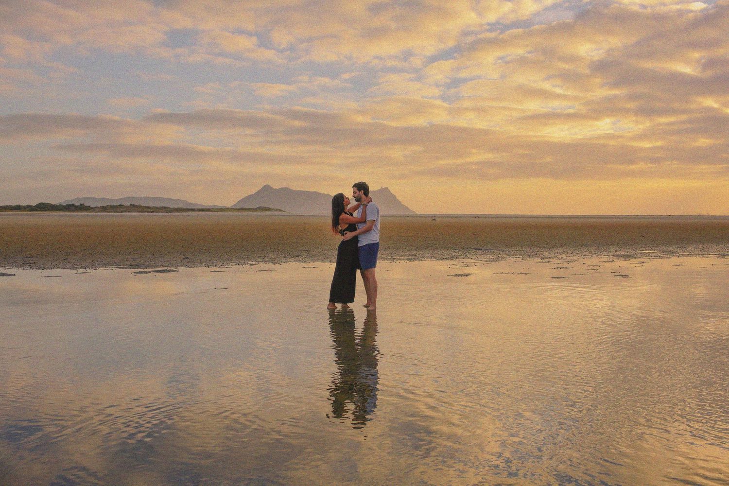 Couples Photographer based in Auckland. With the water reflecting the couples dance.