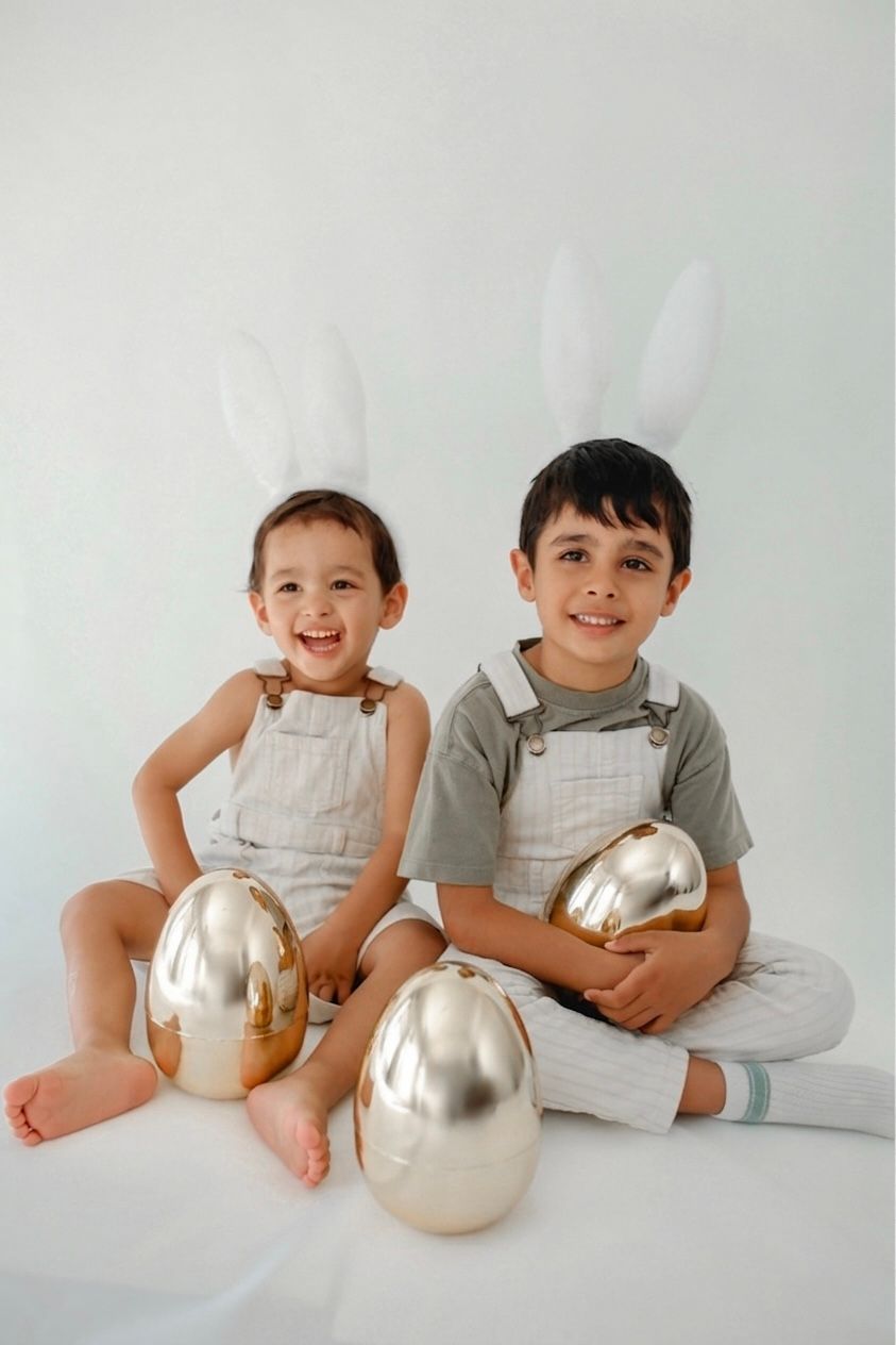 Candid photo of a child wearing bunny ears in a studio set.