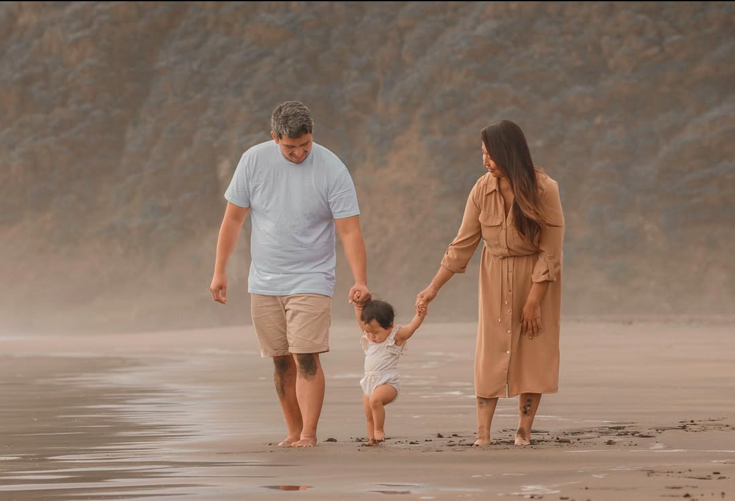Family session at Piha, during sunset. With toddler learning to walk, taking her first steps.