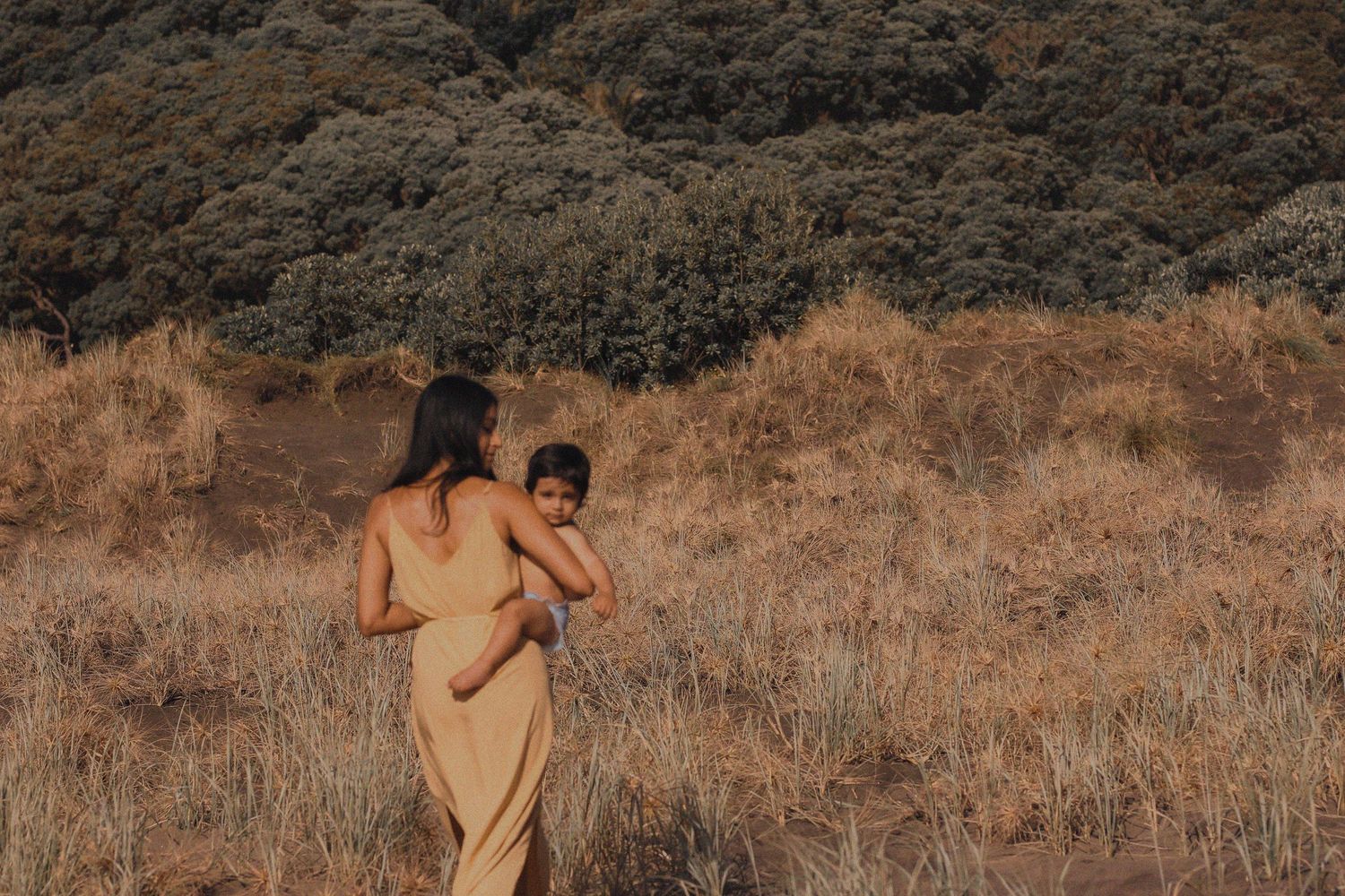 Natural organic photography style, with mum dressed in earthy tones and baby nude.