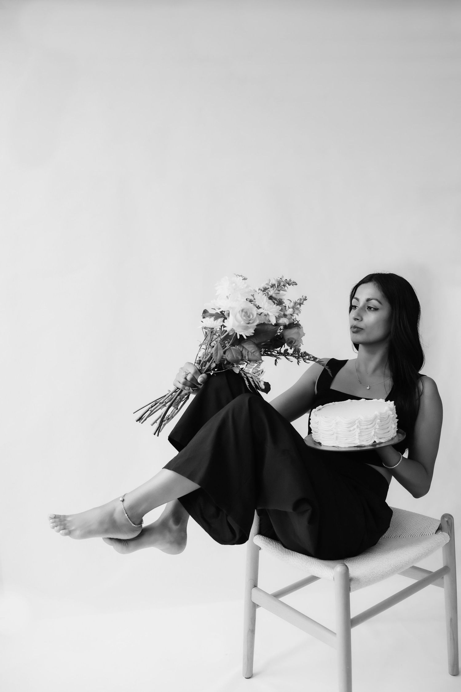 The professional photographer behind Golden Petals Photography, holding a camera in a natural outdoor setting