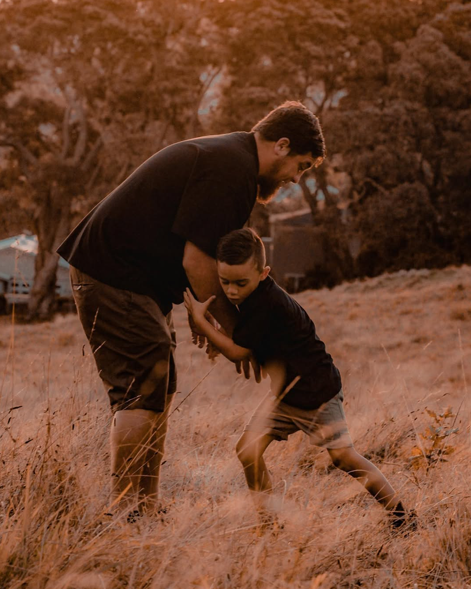 Candid moment of a father lifting his boy.