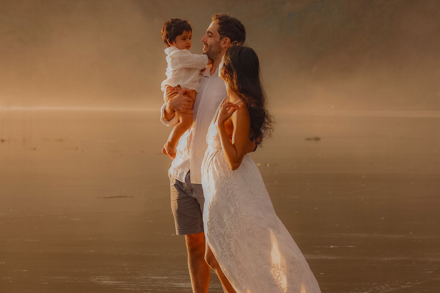 Family photo during golden hour at piha amongst the mist.