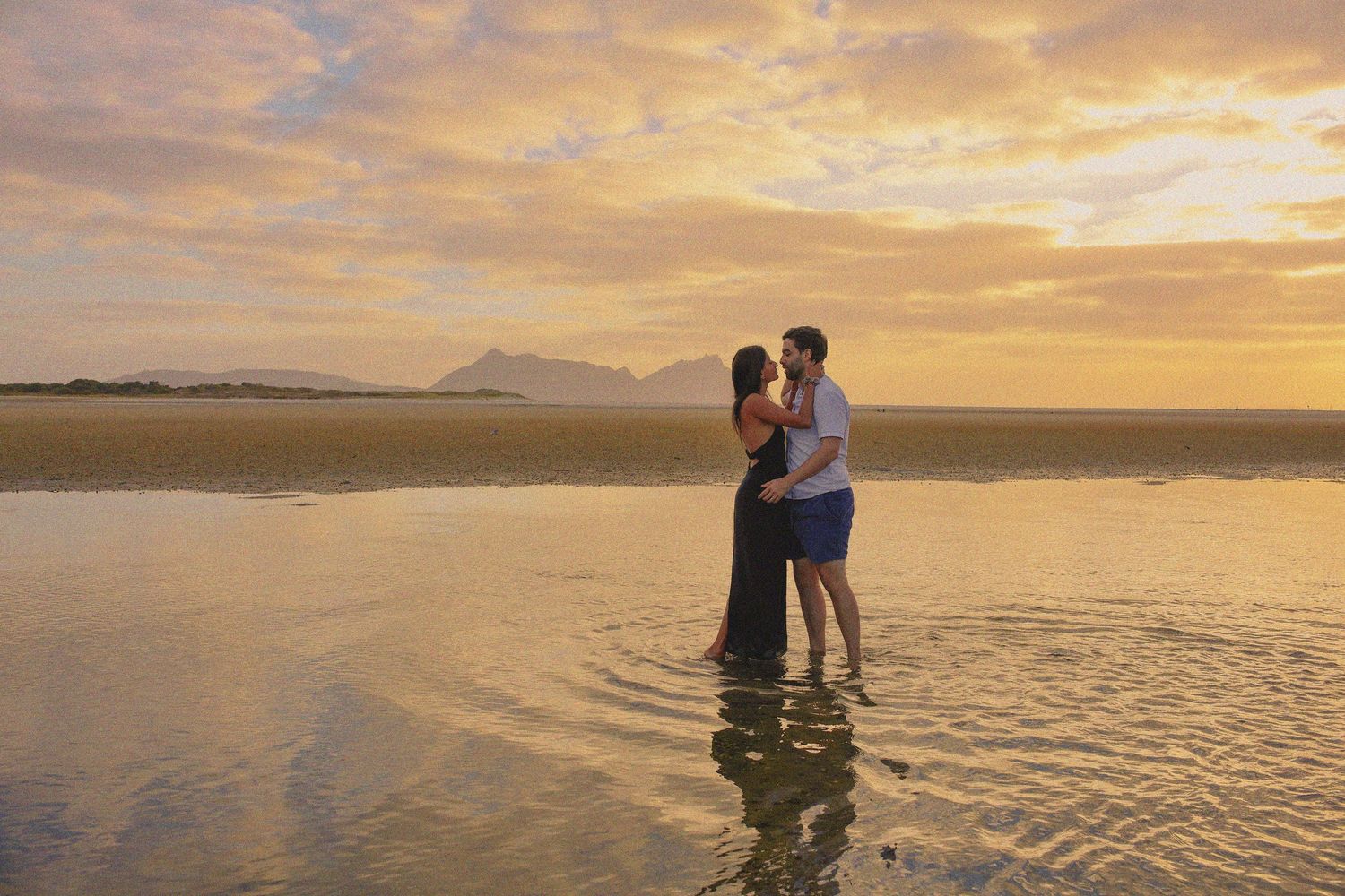 Bright and sun-drenched summer beach session at Long Bay with blue water and white sand.