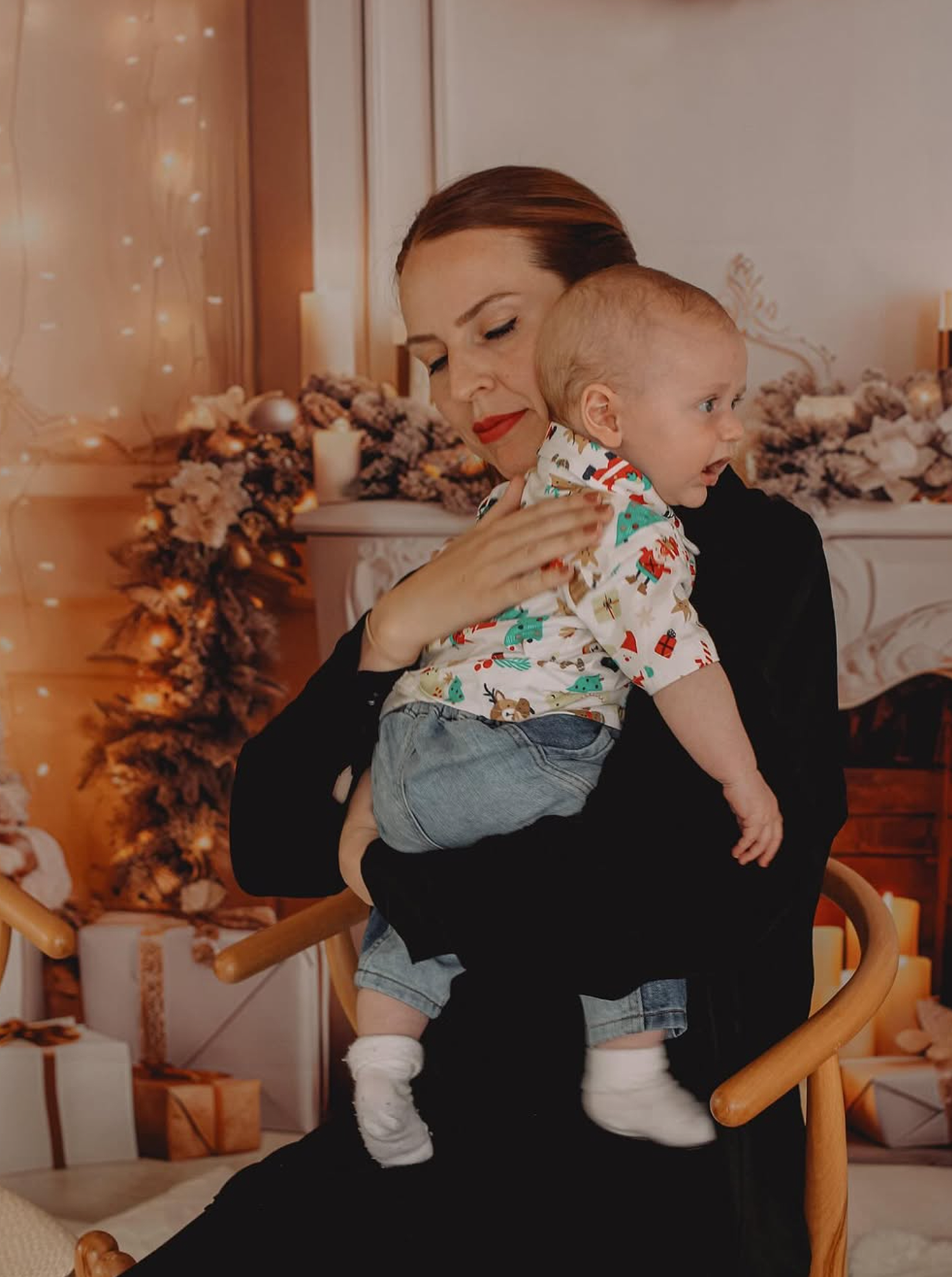 Family portrait on a cozy Christmas set with warm fairy lights and ornaments.