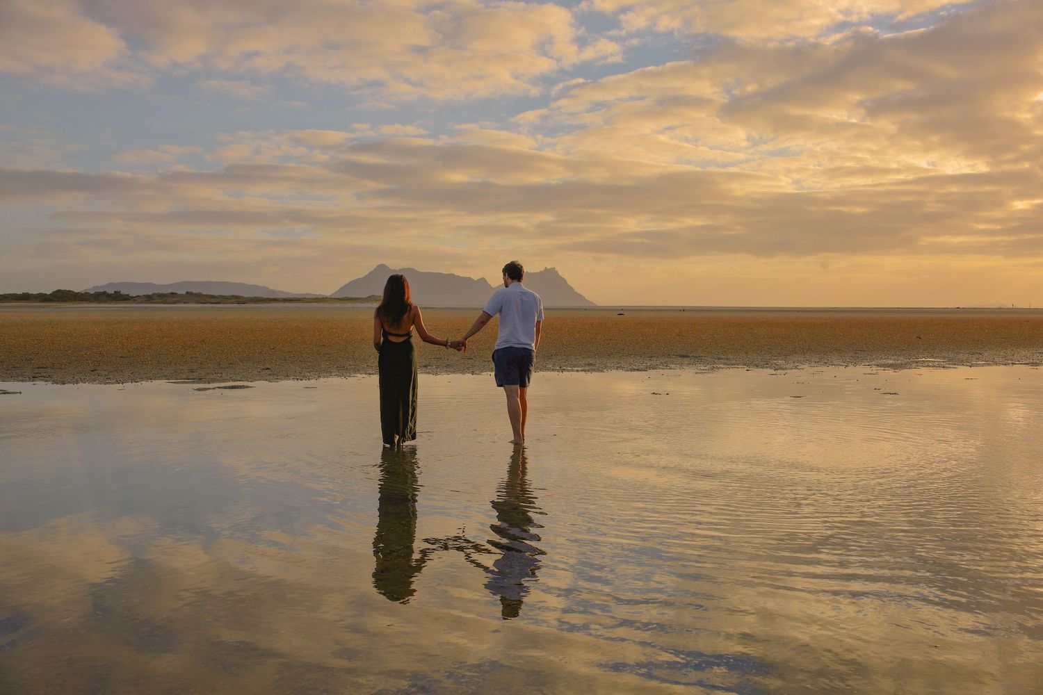 Family Photographer based in Auckland. Couple doing first dance, and walking towards sunset.